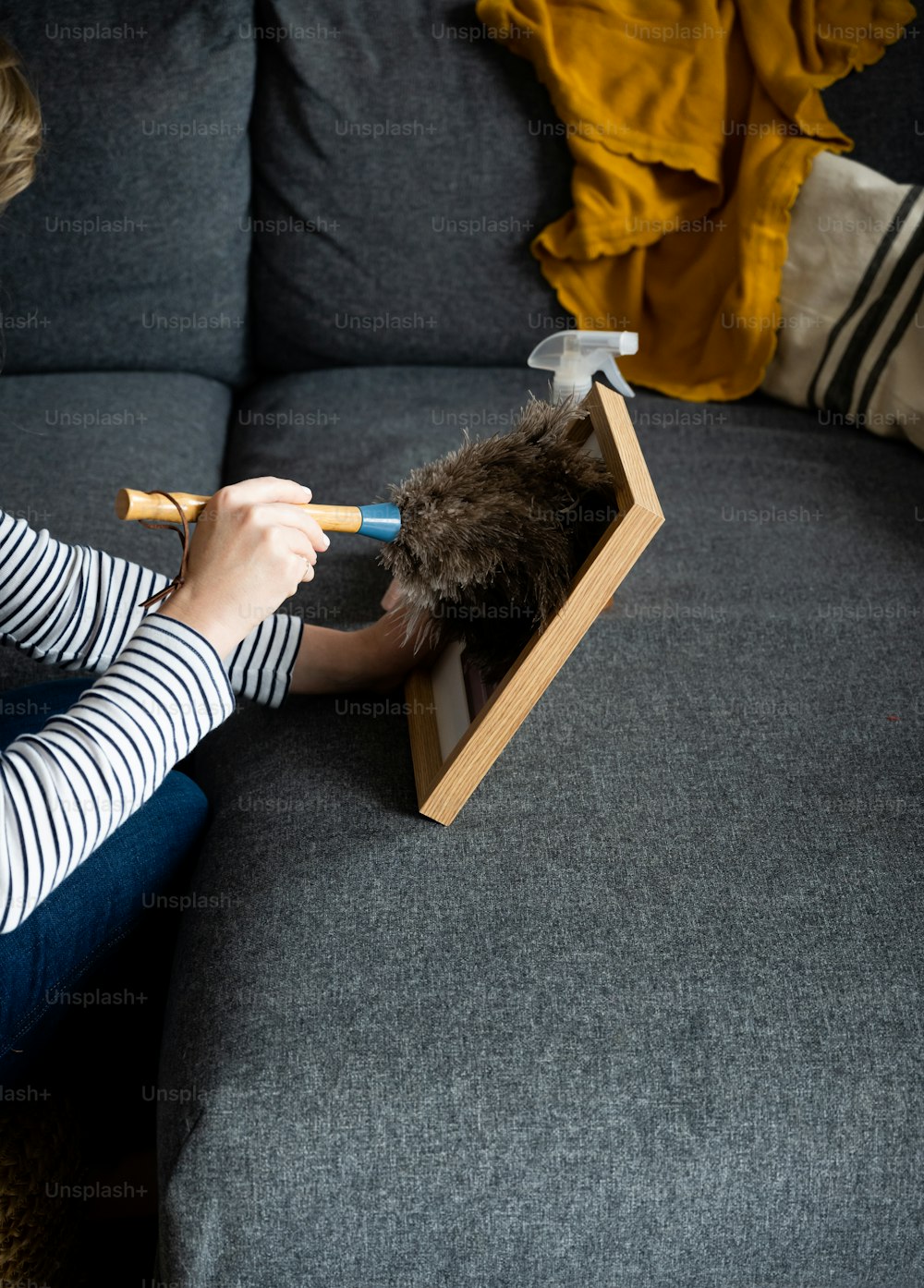 a woman sitting on top of a couch holding a pair of scissors
