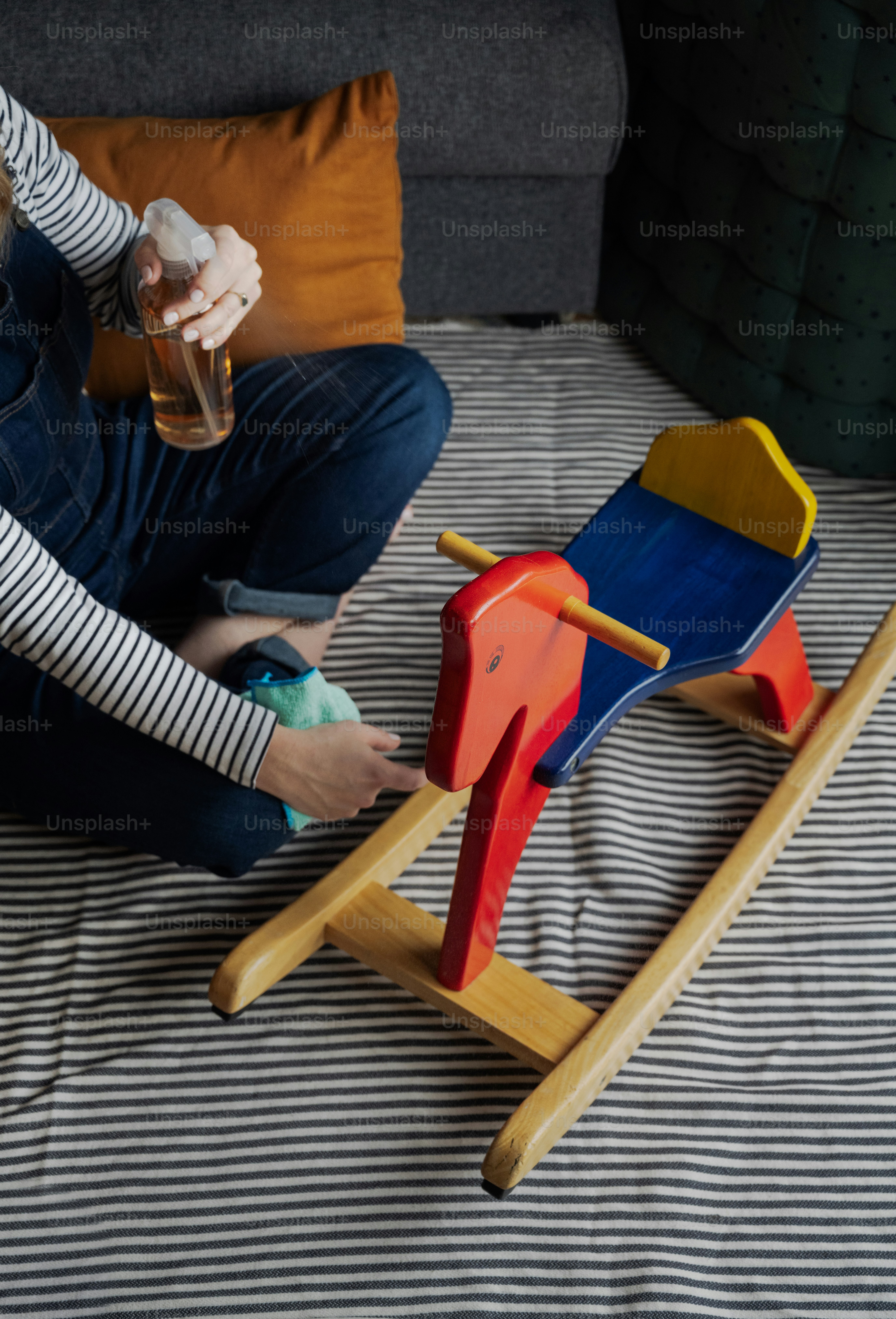 a person sitting on a bed with a toy horse