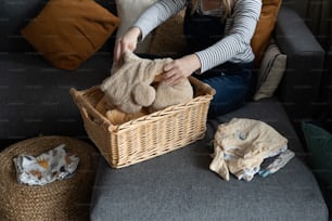 a woman sitting on a couch holding a stuffed animal