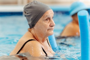 a woman in a swimming cap is in the water