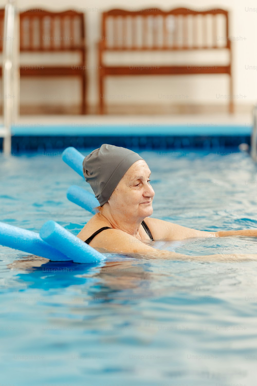 a woman in a swimming pool with paddles