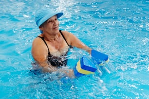 a woman in a pool playing with a ball
