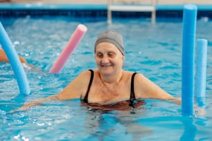 a woman in a swimming pool wearing a hat