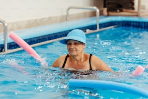 a woman in a pool wearing a blue hat