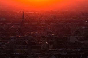 the sun is setting over a large city