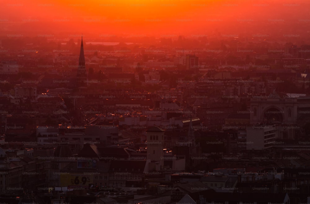 the sun is setting over a large city