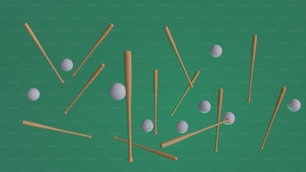 a group of sticks and balls on a green surface
