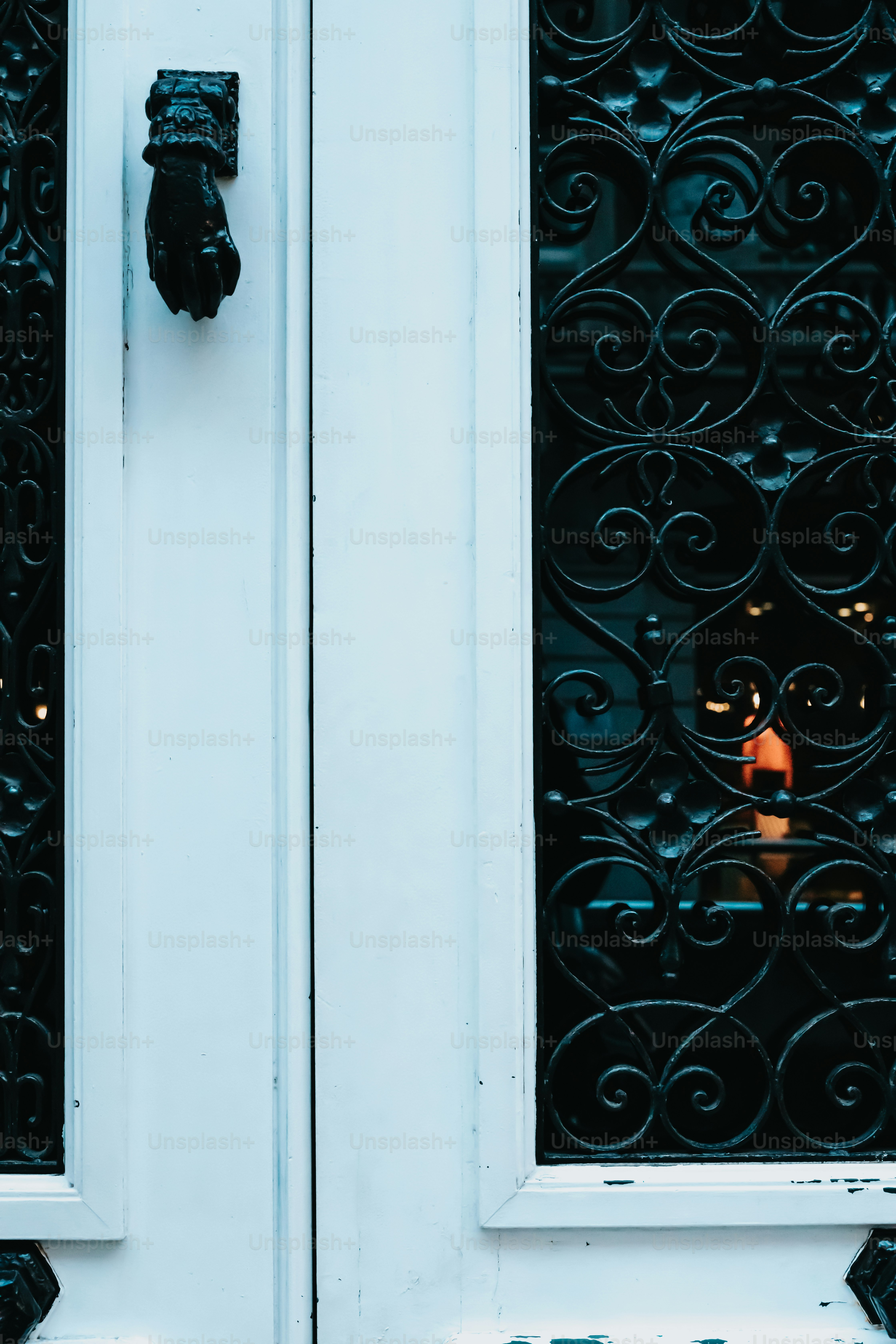 a close up of a door with a candle in the window