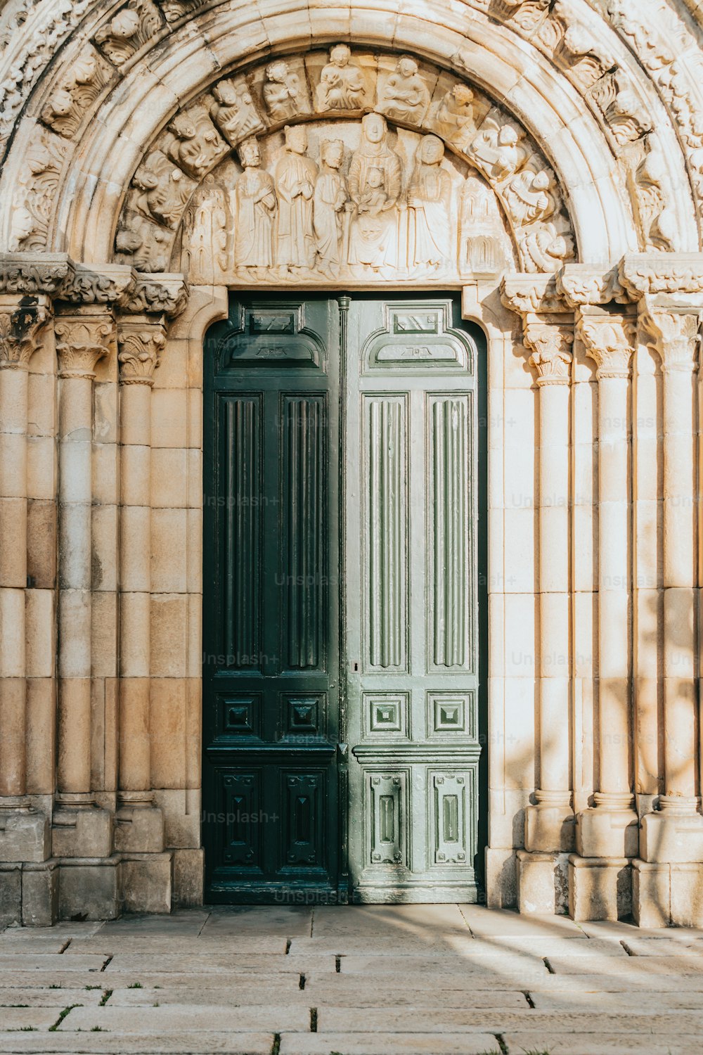 石造りの建物の前に座っている大きな緑のドア