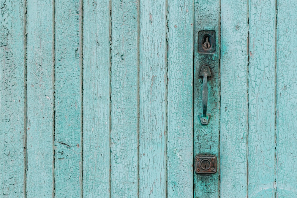 a door handle on a blue wooden door