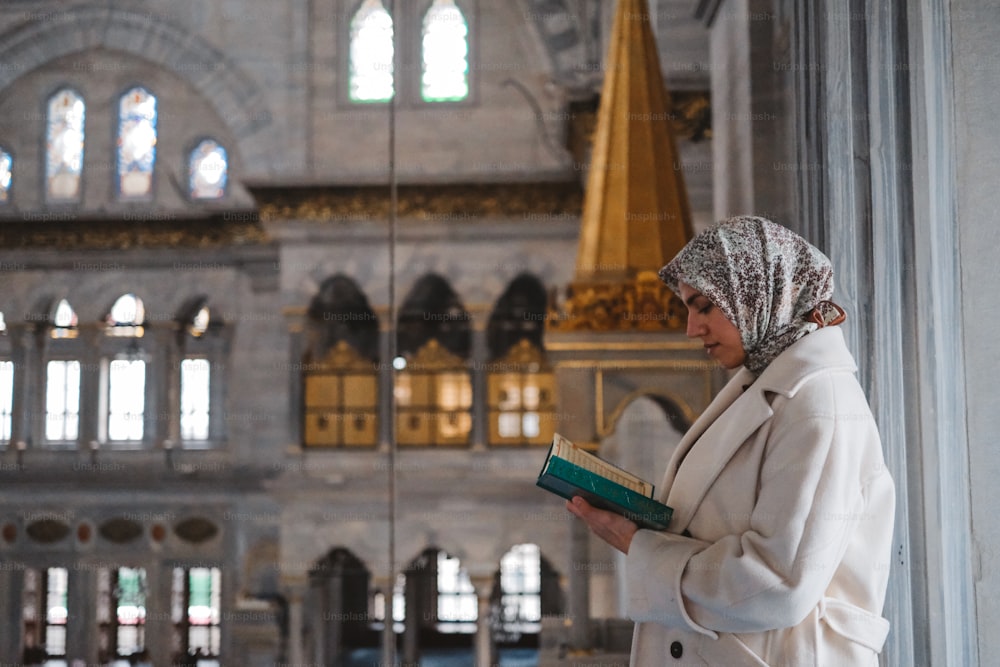a woman in a headscarf reading a book
