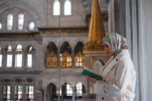 a woman in a headscarf reading a book
