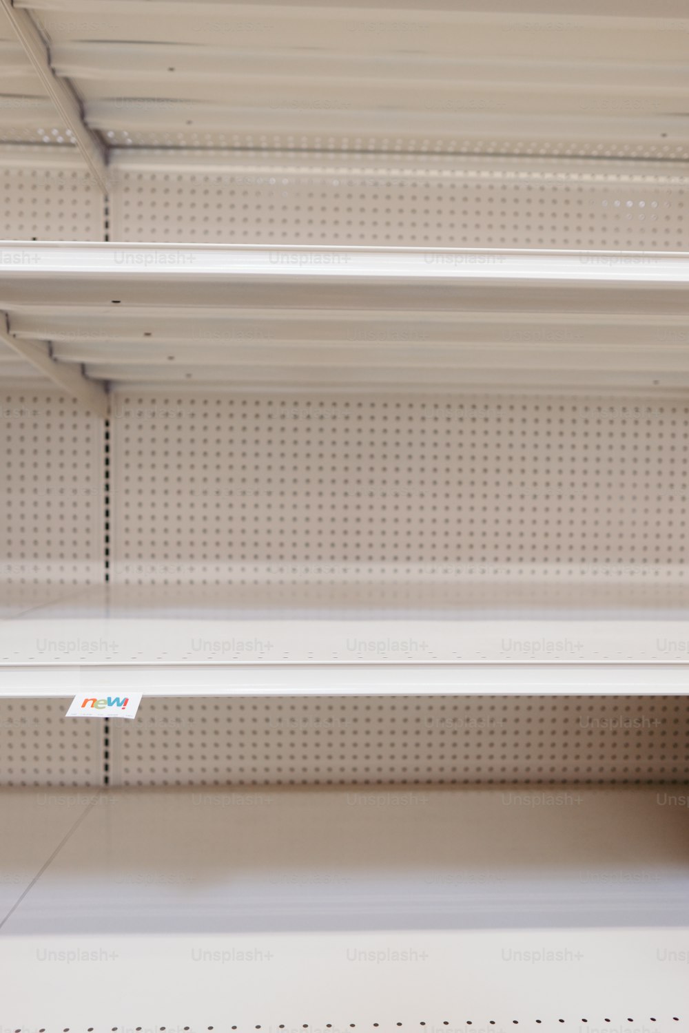 empty shelves in a store with price tags on them