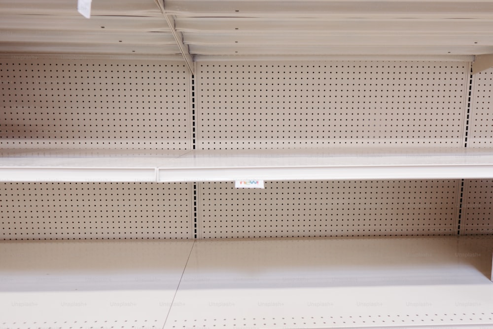 a empty shelf in a store with a price tag