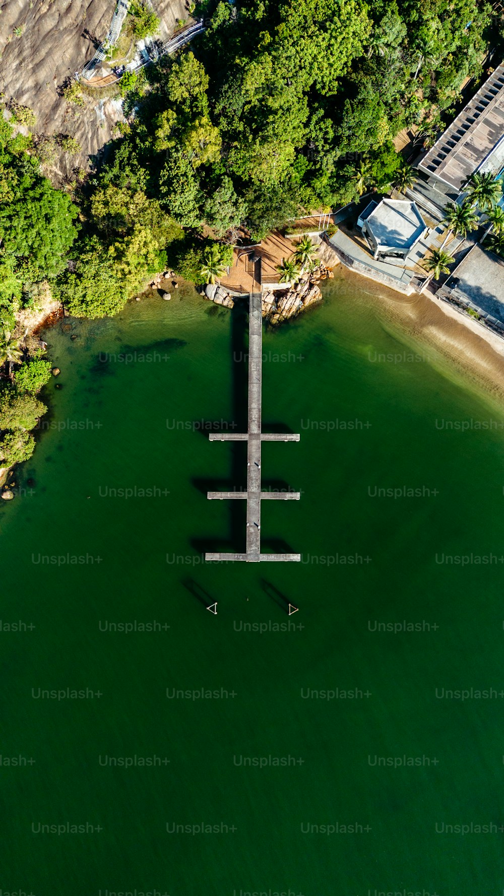 an aerial view of a dock in the middle of a lake