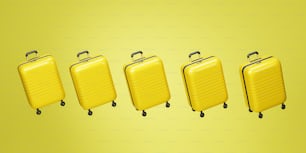 a group of four yellow suitcases sitting next to each other
