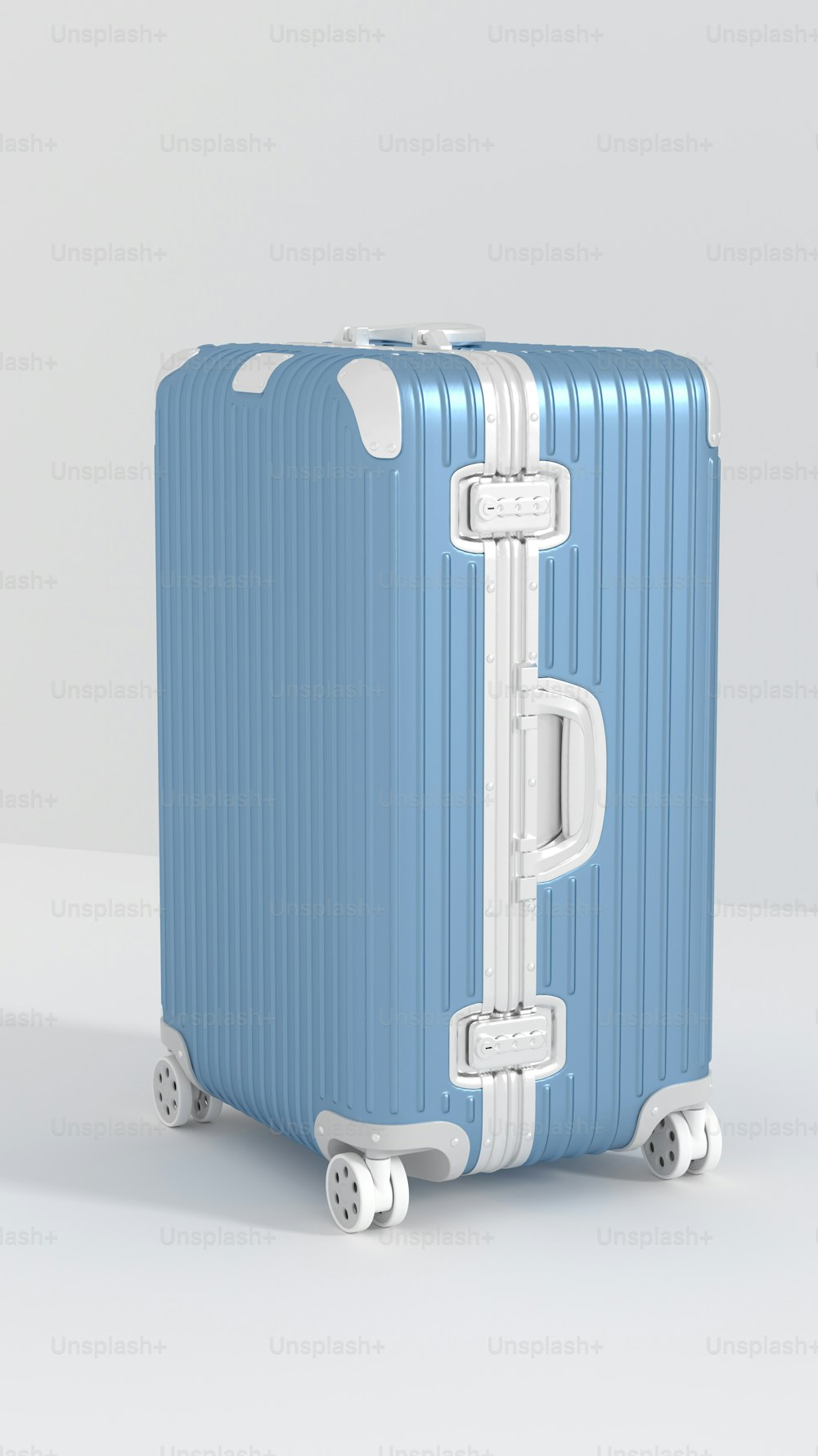 a blue and white suitcase sitting on wheels