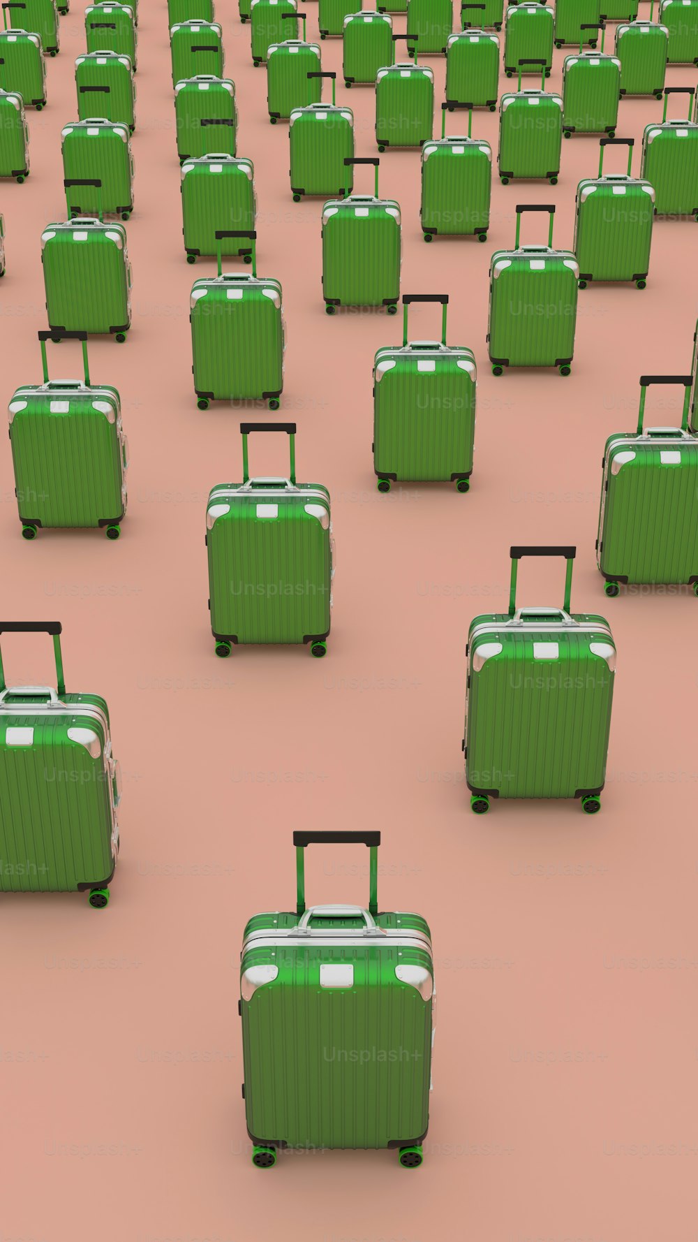 ピンクの床の上に座っている緑のスーツケースのグループ