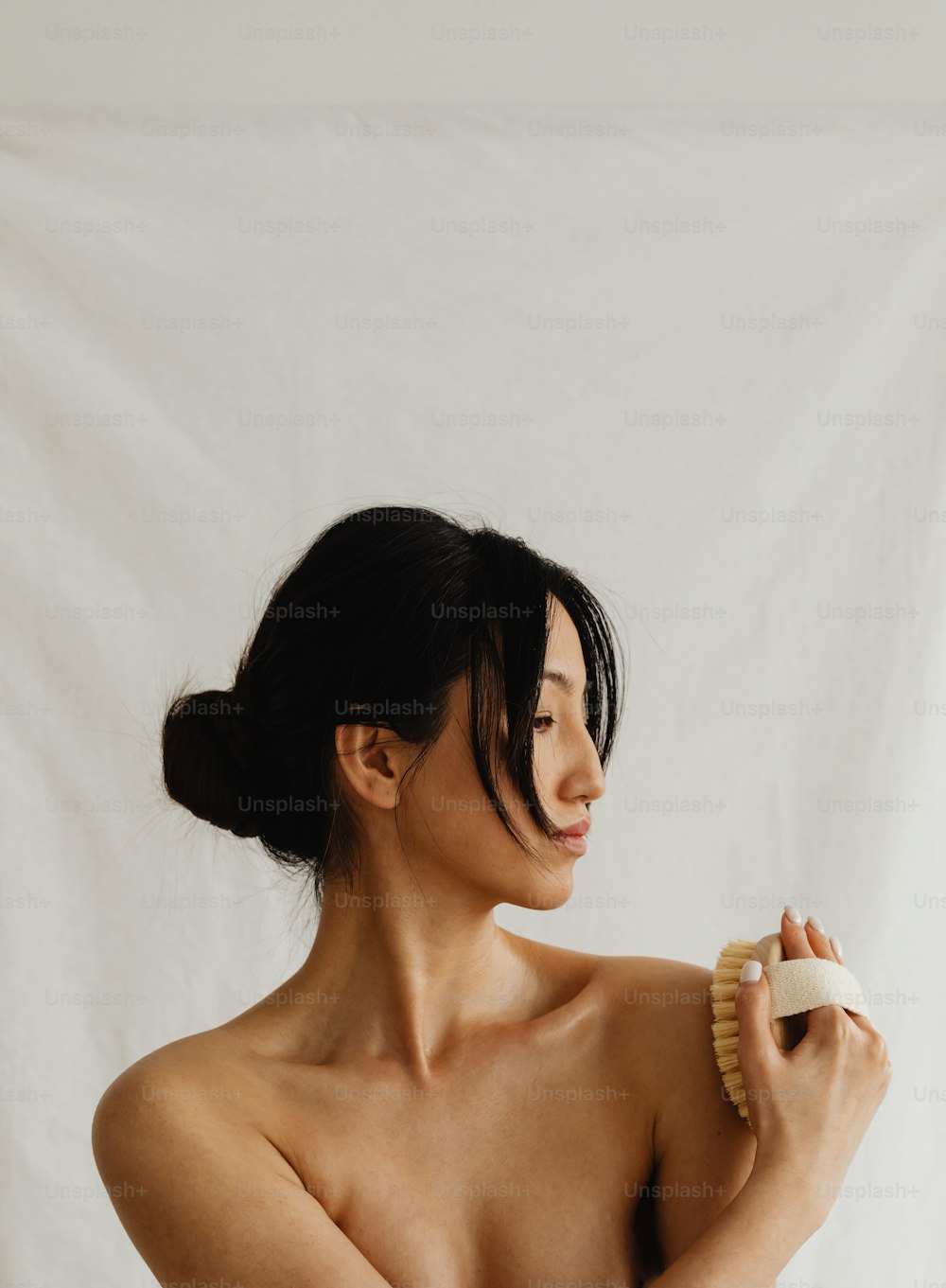 a woman brushing her hair with a brush