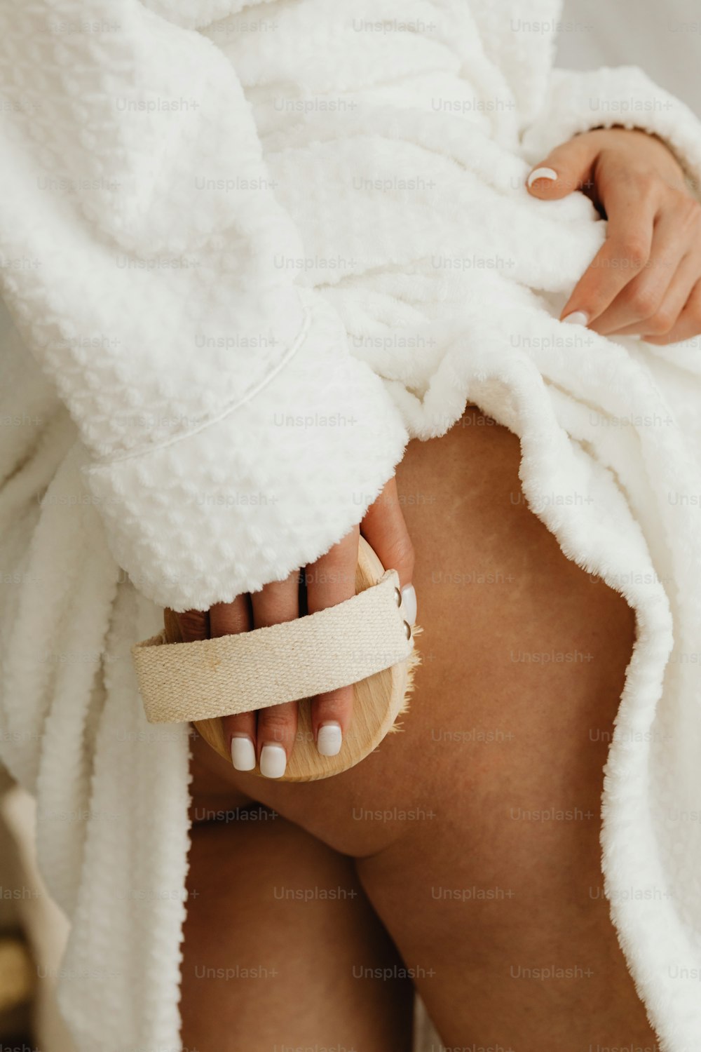 Una mujer en bata de baño sosteniendo una toalla