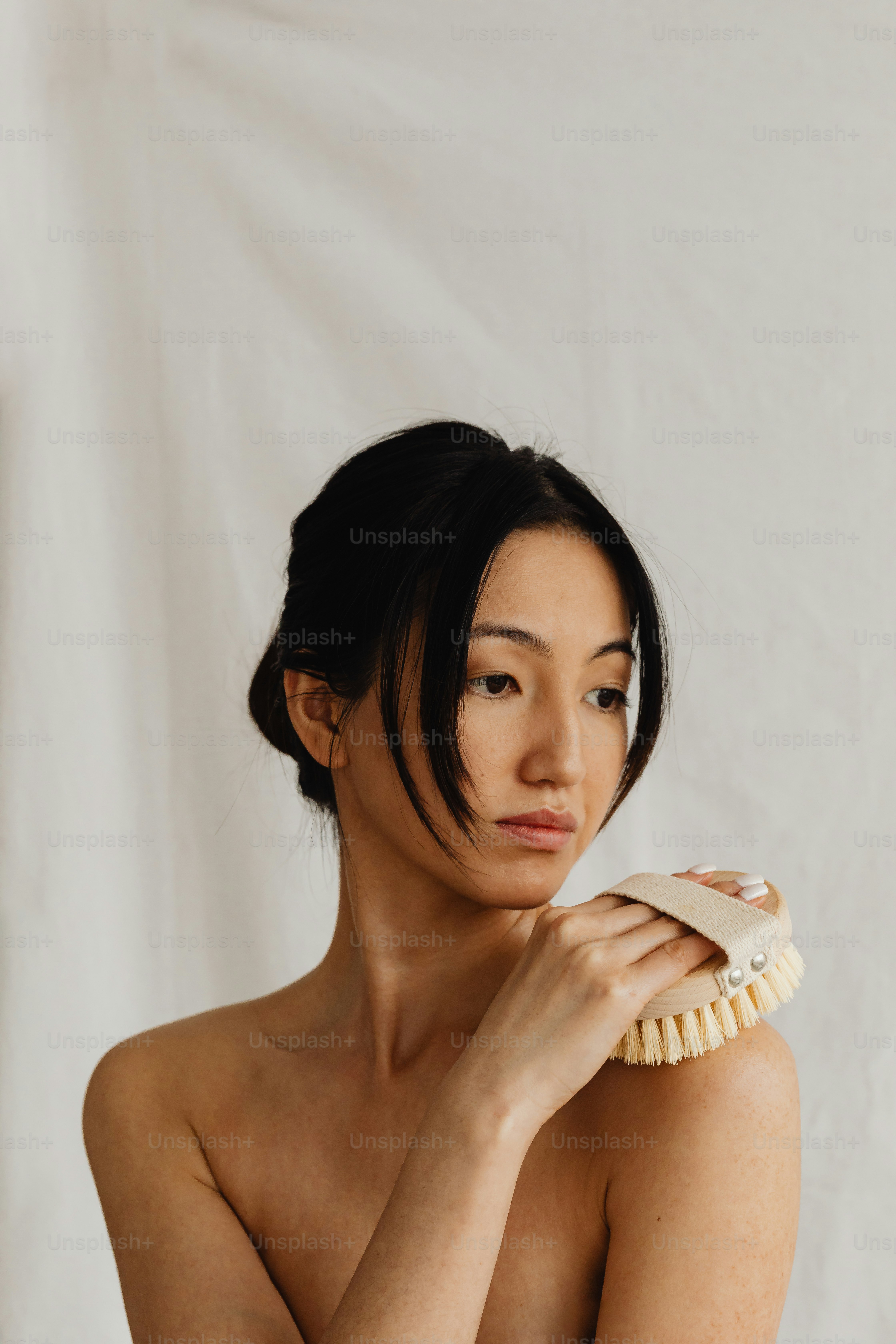 a woman brushing her hair with a brush
