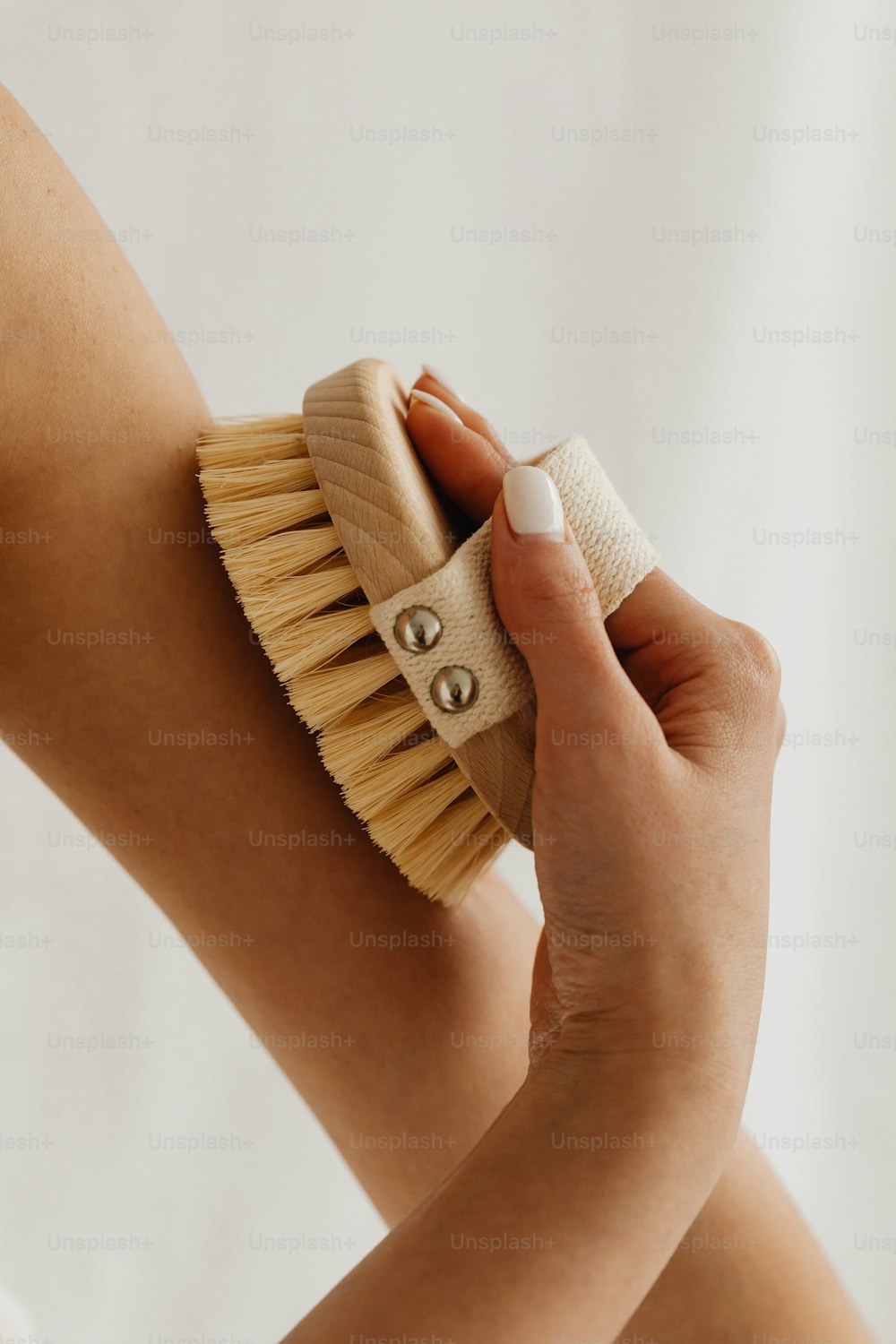 a woman is holding a brush in her hand