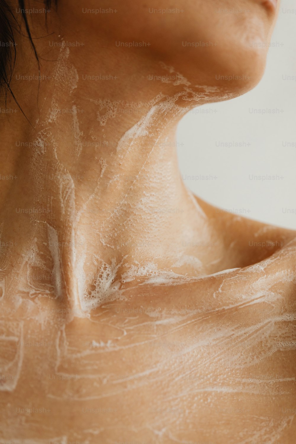 a close up of a woman's back with a lot of white stuff on