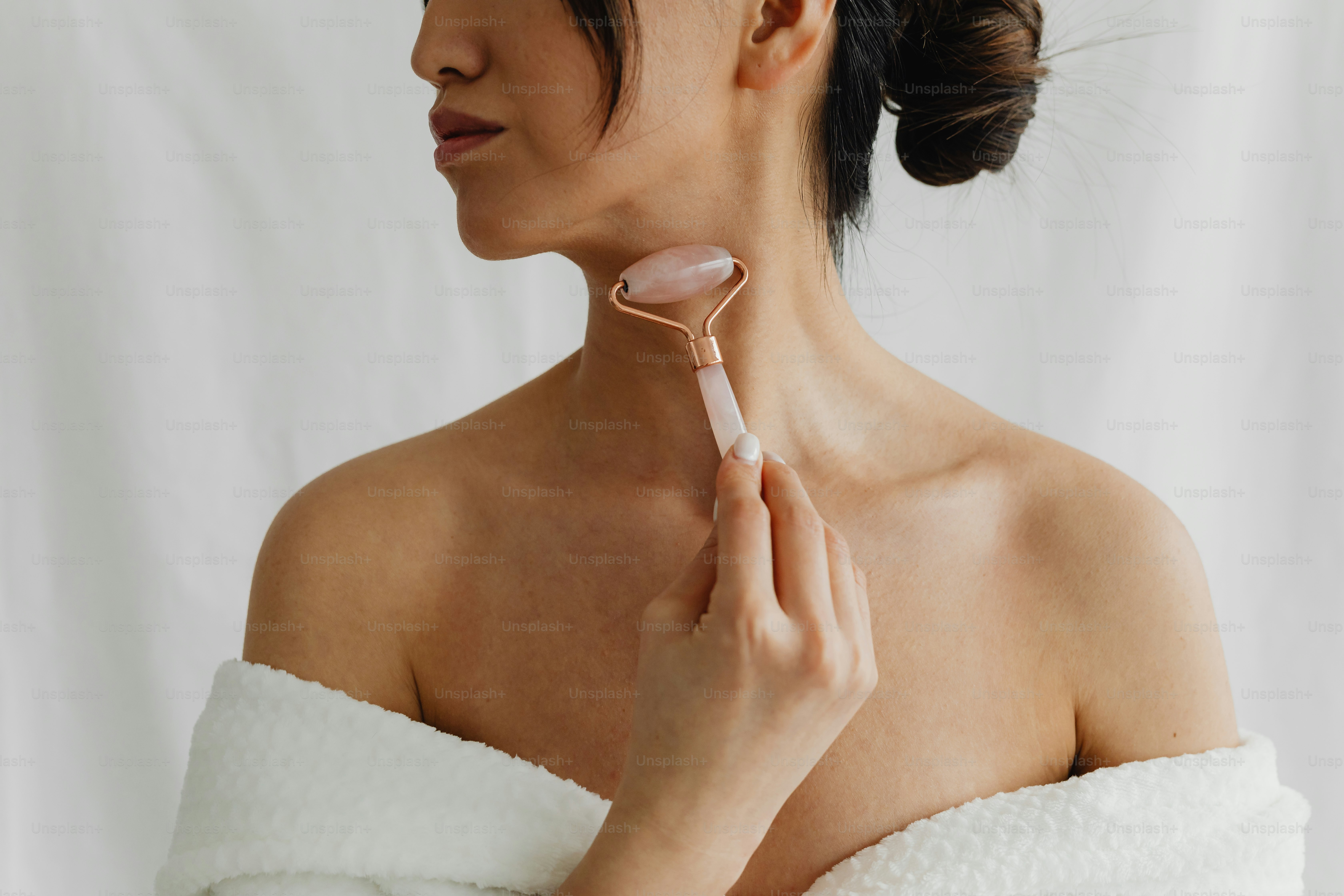 a woman in a white towel is holding a hair brush