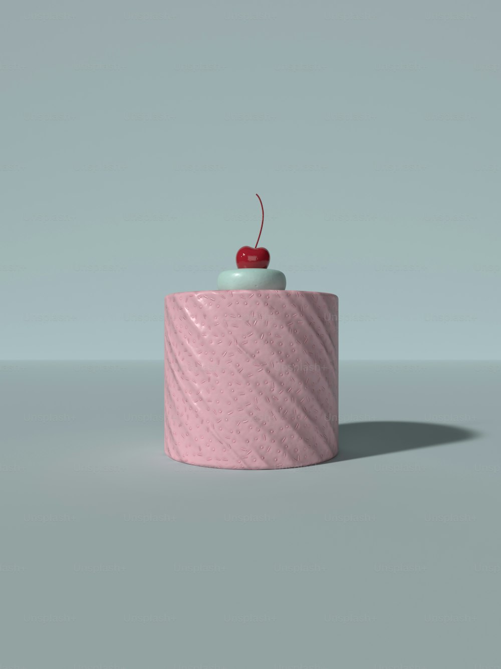 a pink object with a cherry on top of it
