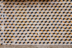 a close up of a tiled wall with yellow and black squares
