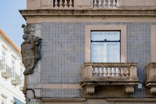 a blue and white building with a window and balcony