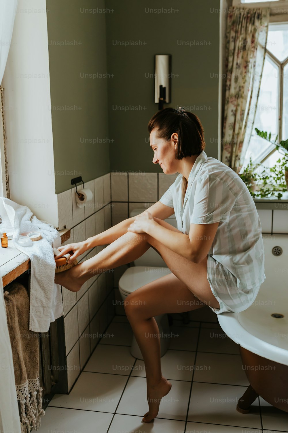 a woman sitting on a toilet in a bathroom