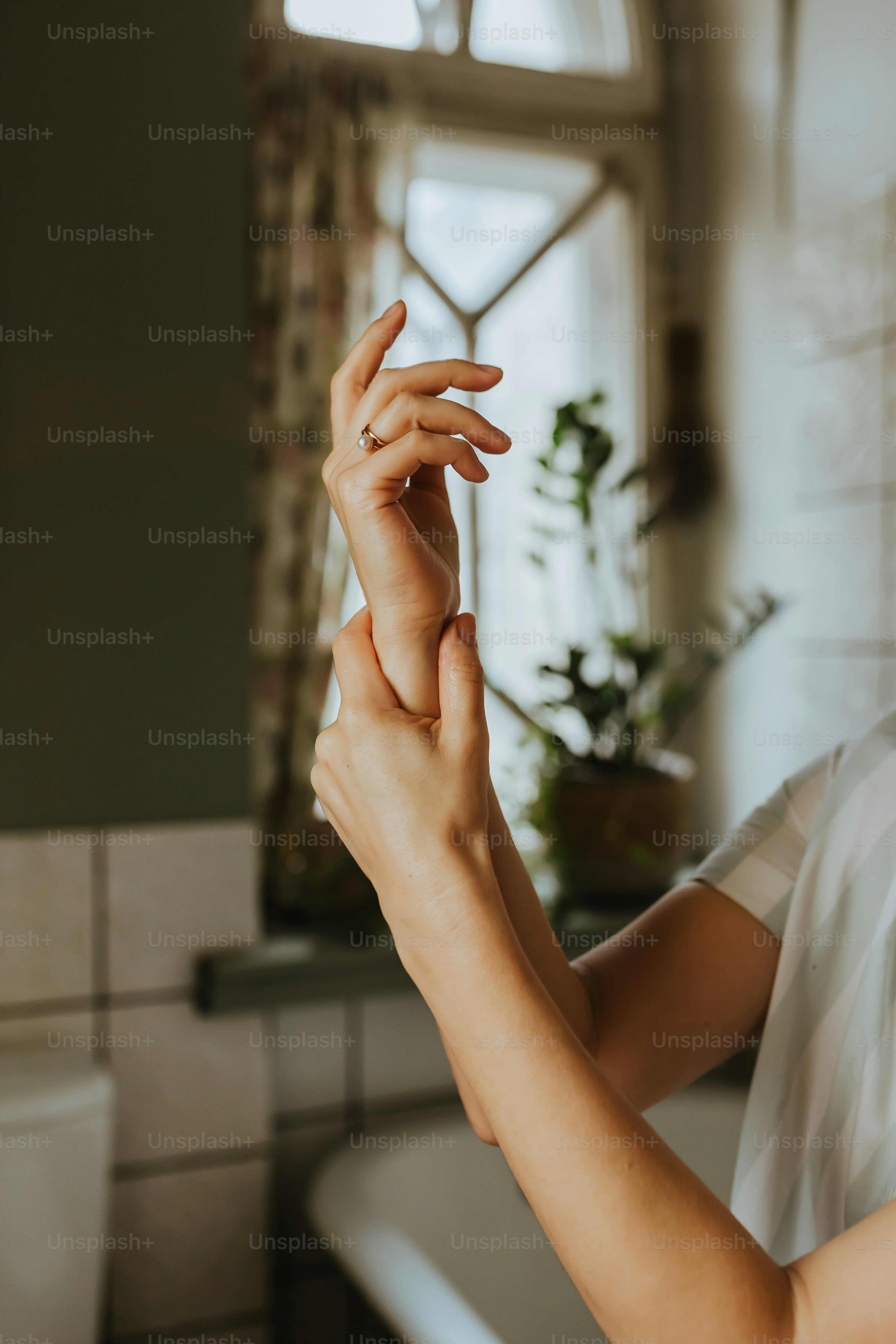 a woman holding her hands up in the air