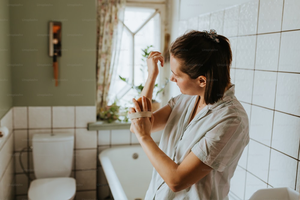 Une femme se brossant les dents dans une salle de bain