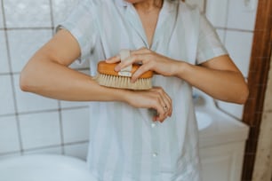 Una mujer se cepilla el pelo con un cepillo