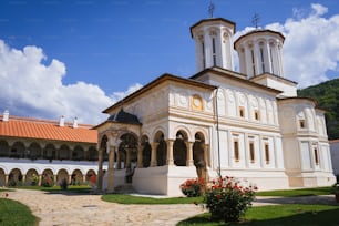 a large white building with a clock on it's side