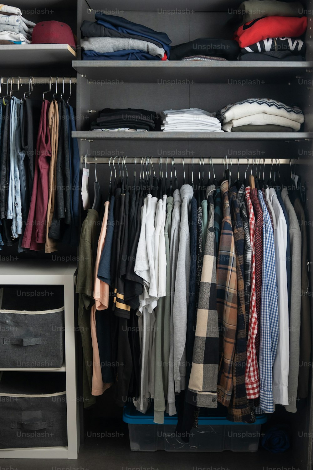 a closet filled with lots of different types of clothes