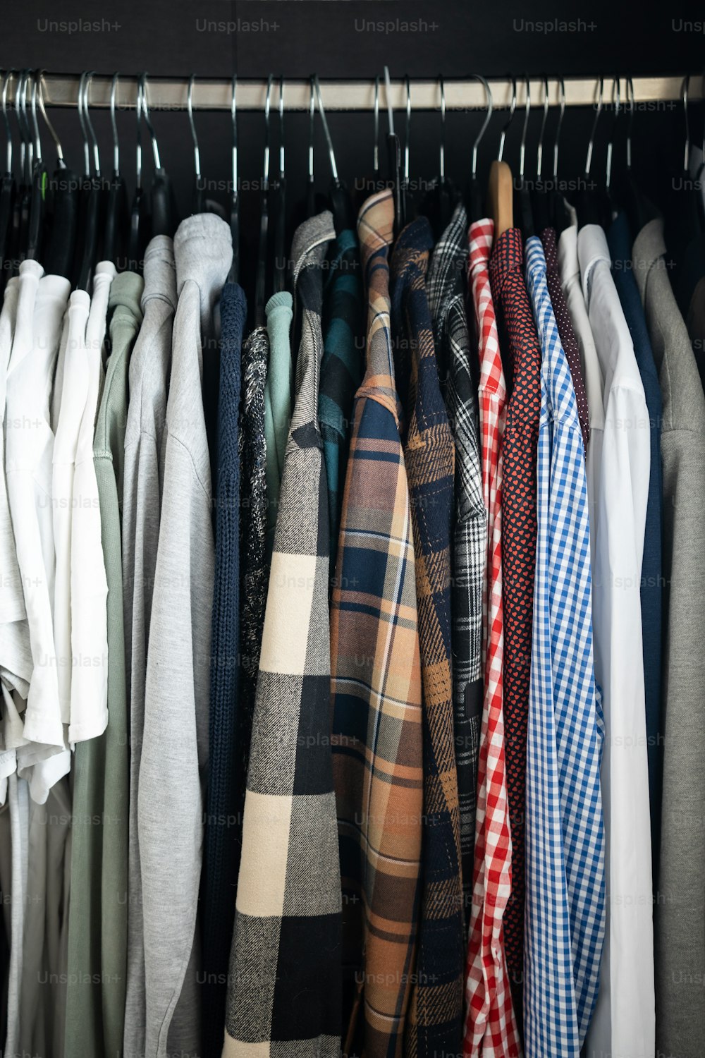 a bunch of shirts hanging on a rack