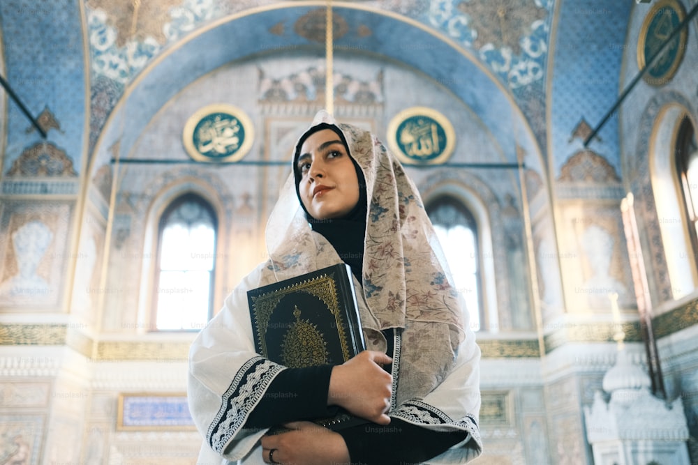 a woman wearing a veil and holding a book