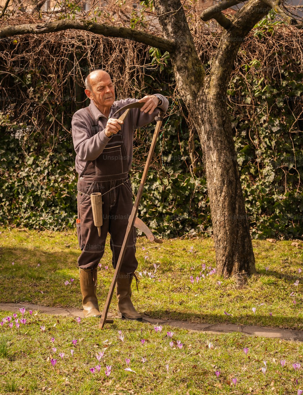 an old man holding a stick in a park