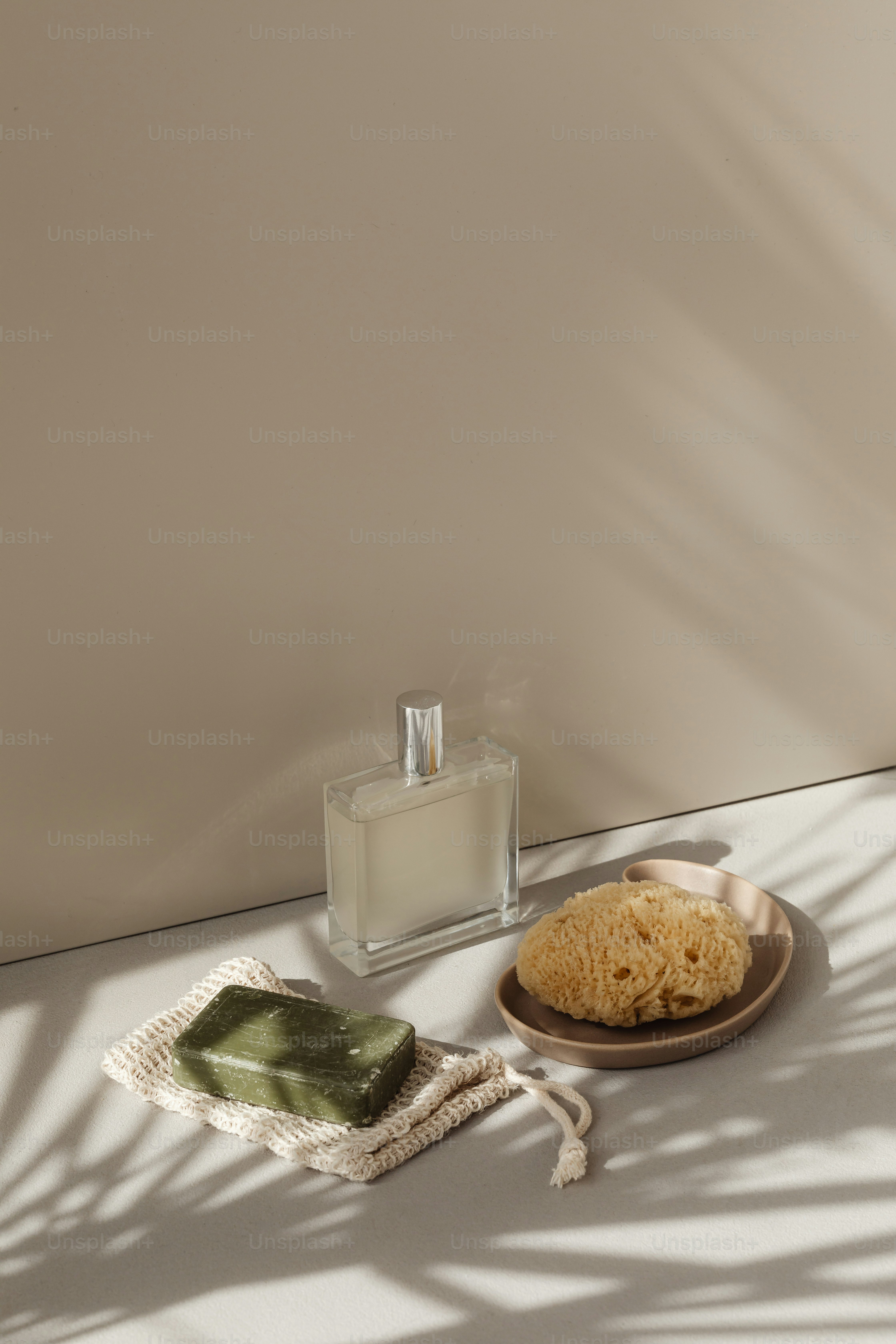 a plate of noodles next to a bottle of perfume