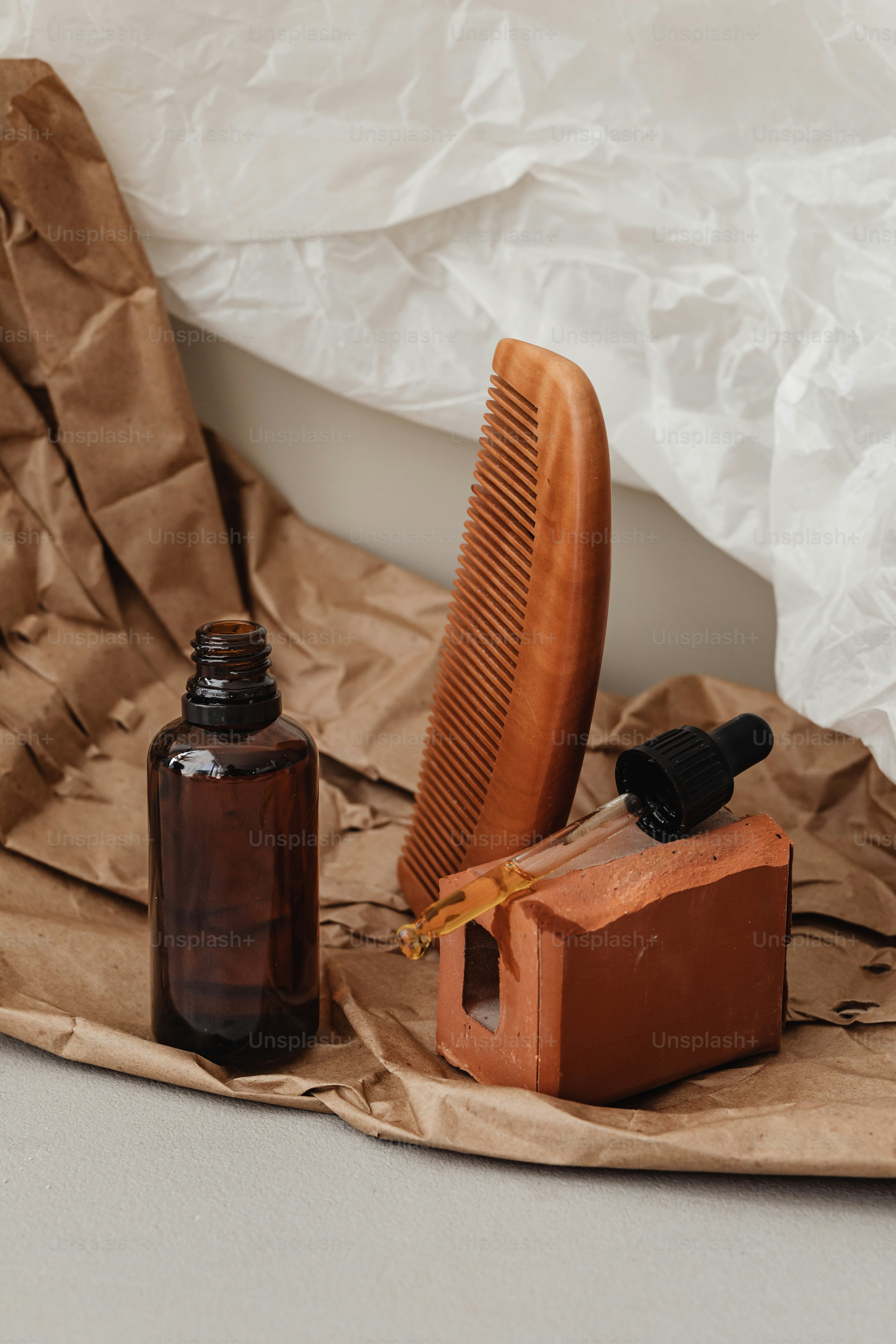 a wooden comb sitting on top of a table next to a bottle