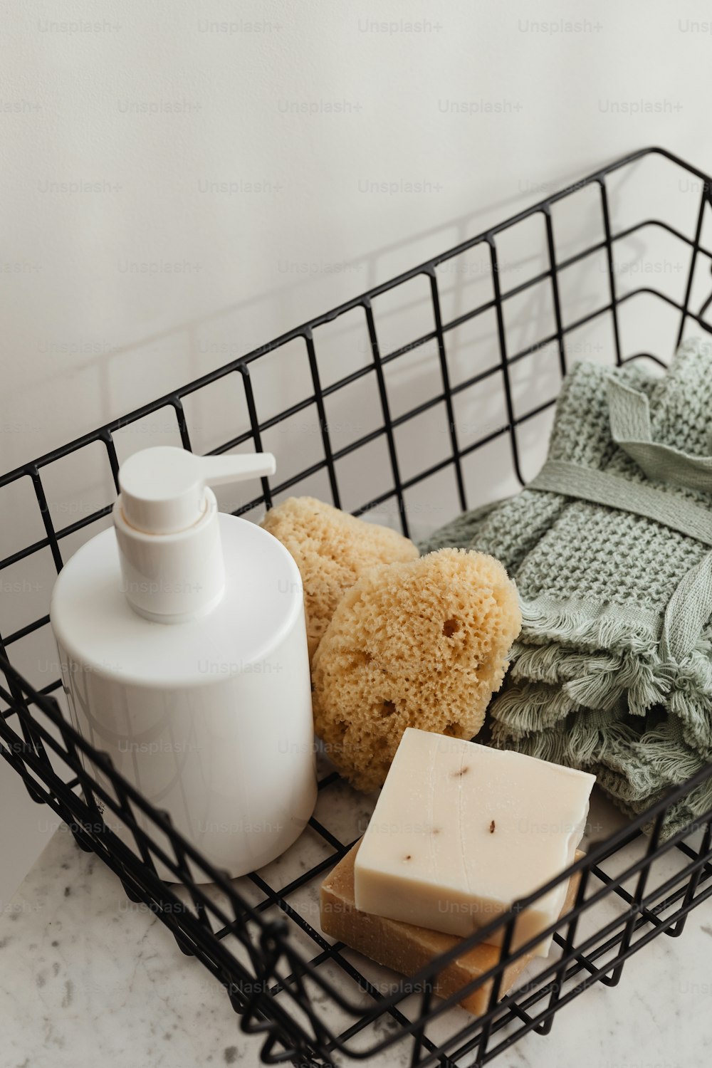 a basket with soap, a soap bar, and a teddy bear