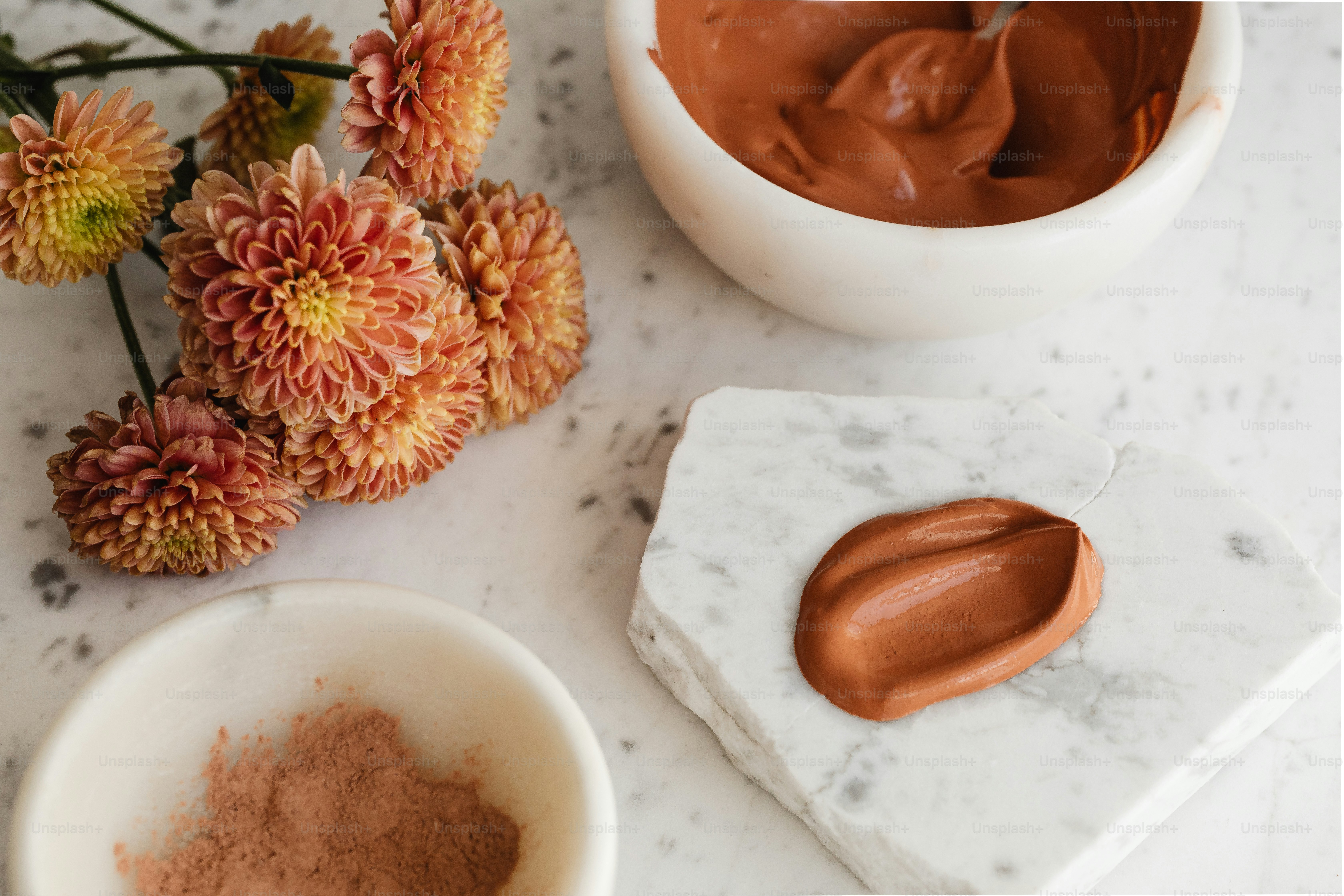 a marble table topped with a bowl of chocolate