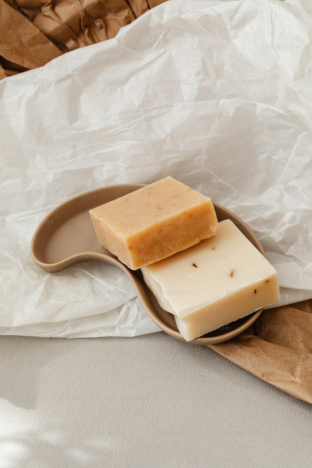 a couple of pieces of soap sitting on top of a wooden spoon