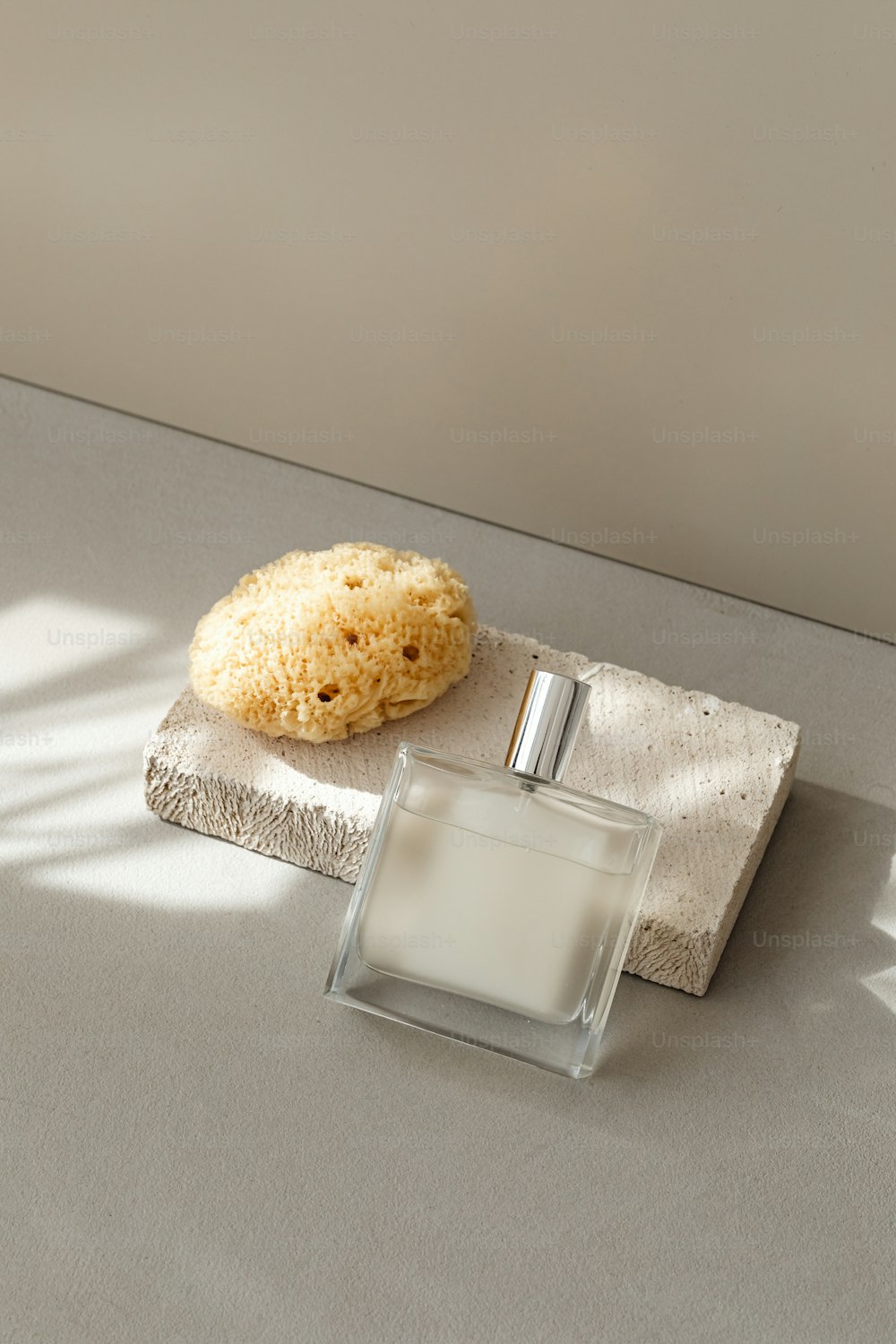 a bottle of cologne next to a cookie on a napkin