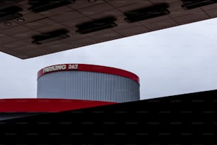 a red and white building with a sky background