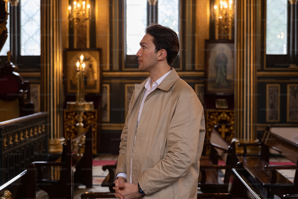 a man standing in a church looking off into the distance