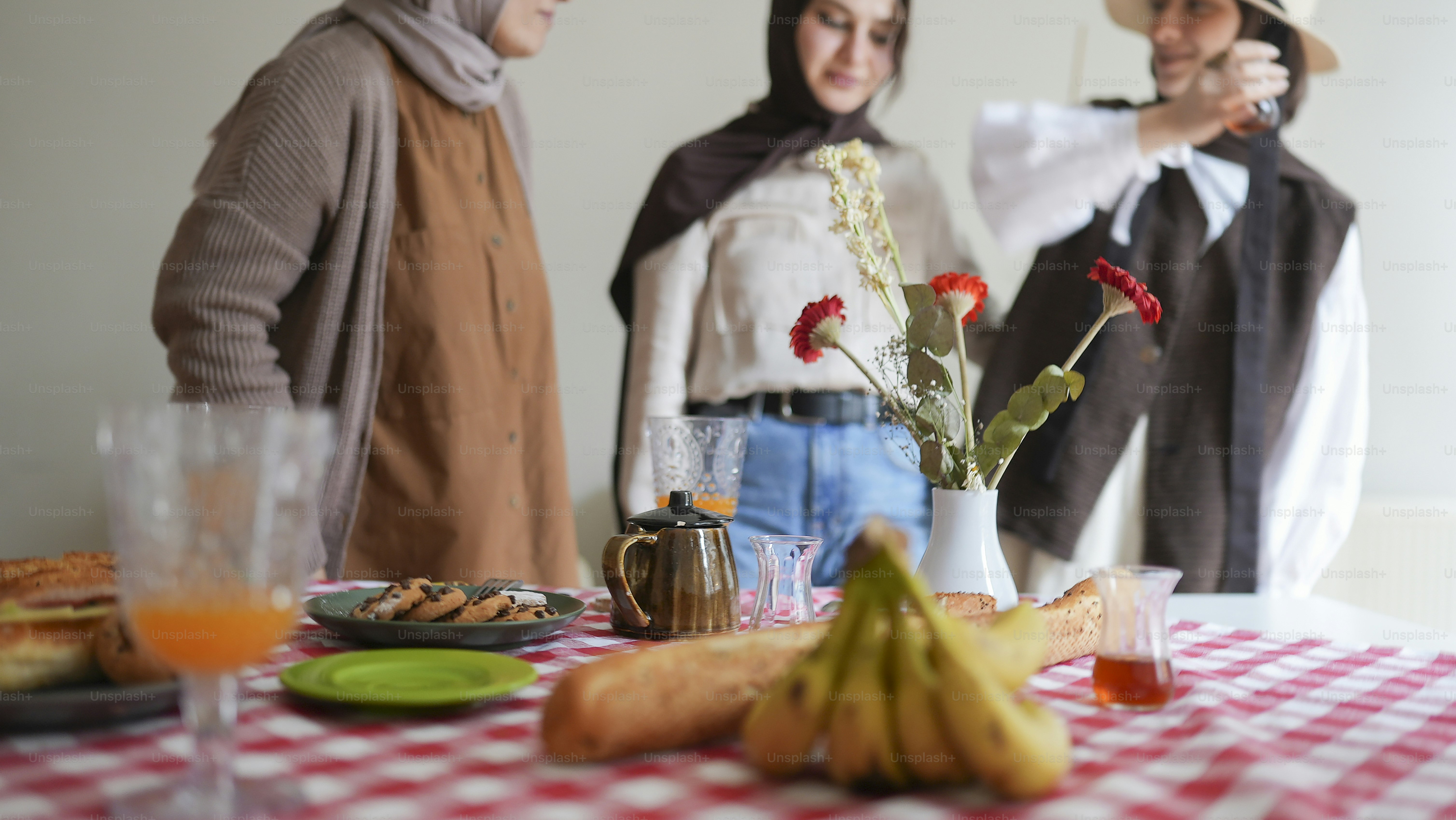 A group of people standing around a table with food photo – Food Image ...