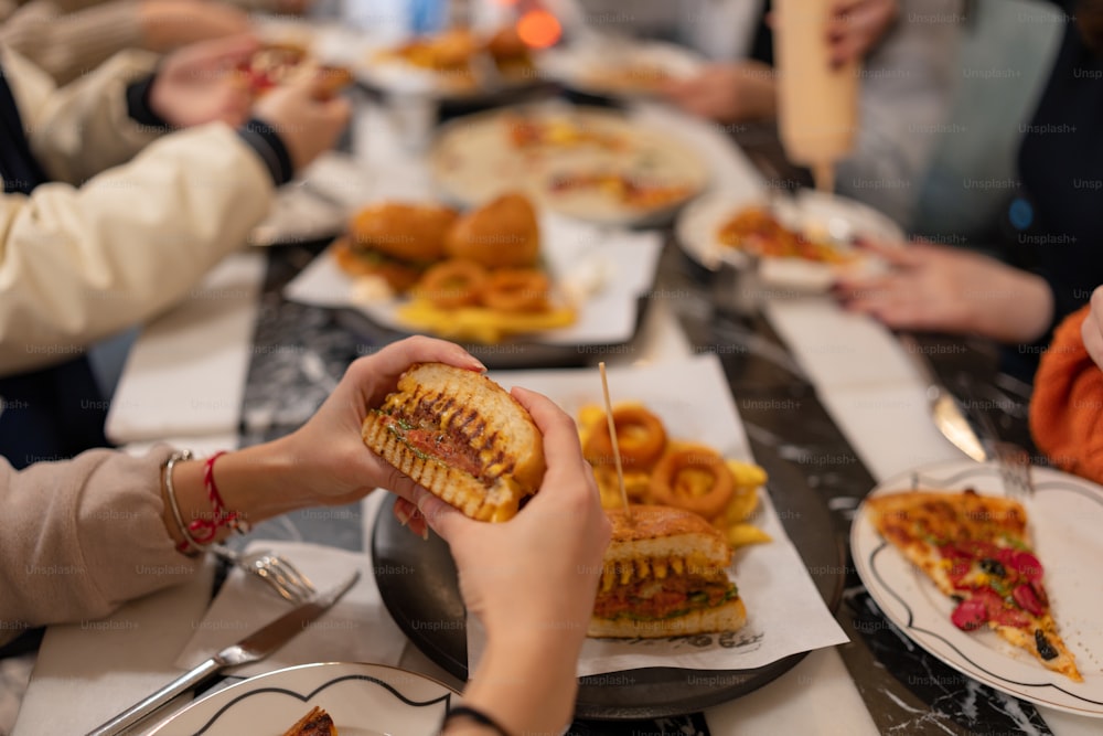 a group of people sitting around a table eating food